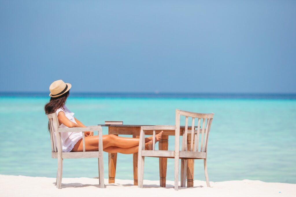 young-woman-reading-at-outdoor-beach-cafe-2026-01-08-05-10-32-utc (Medium)